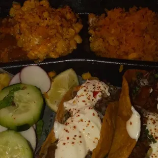 Taco, beans, rice, esquite, cucumbers, and raddish.