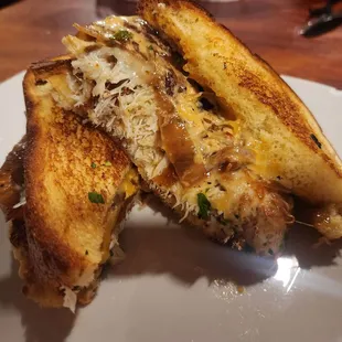 CRAB CAKE GRILLED CHEESE 6oz of crab cake nestled between layers of Texas toast with caramelized onions, smoked Gouda, and sharp cheddar