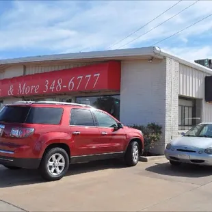 two cars parked in front of the store