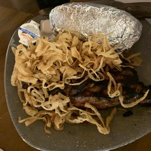 New York Strip with onions and a baked potato