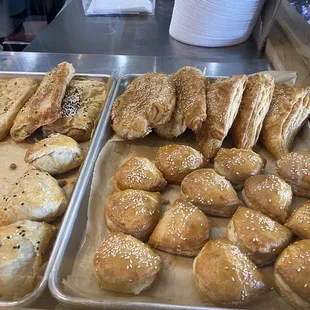 Almost empty pastry display.  Bottom left mushroom filled. Top left potato filled. Top and bottom right cheese filled