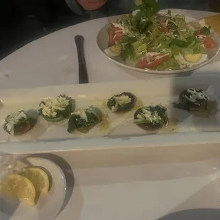a plate of appetizers and a salad