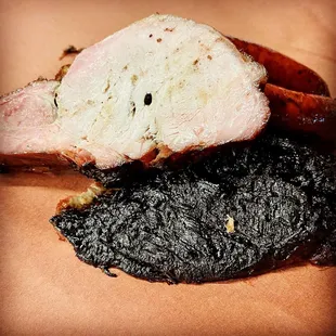a piece of meat with black stuff on it