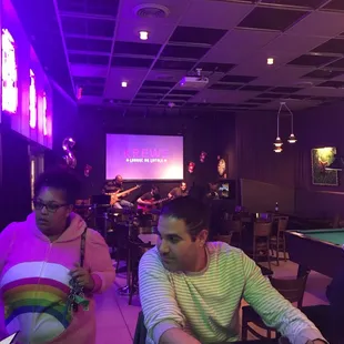 a man sitting at a pool table