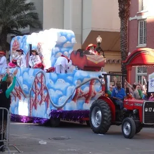 Floats with people reaching for beads