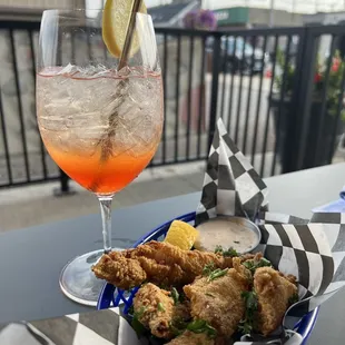 a plate of fried chicken and a drink