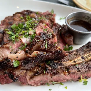 a steak with a side of sauce