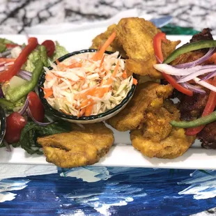 Chicken wings, friend plantain and fresh salad. Spicy cabbage slaw no Mayo extra yummy .