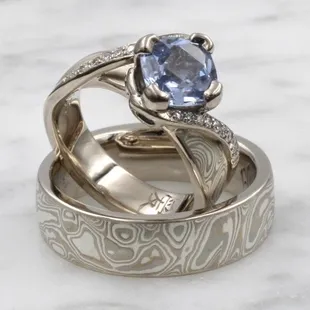 Custom wedding ring set with sapphire engagement ring, Chinese character interior engraving, and Mokume Gane pattern