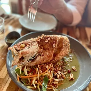 crispy market fish papaya salad, herbs, crispy shallots, scallions, peanuts