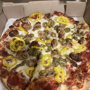 Sausage, green olives, banana peppers pizza.