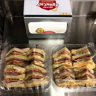 two trays of sandwiches