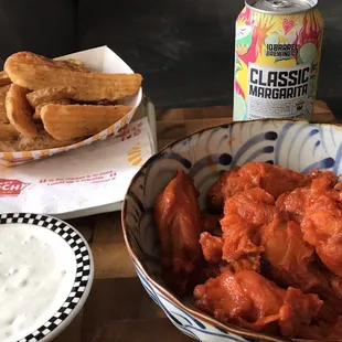 Buffalo wings with potato wedges. Margarita we bought at the liquor store area. We made our bleu cheese dressing.