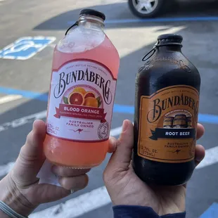 a hand holding a bottle of rum and a bottle of rum