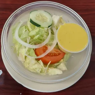 a plate of salad with dressing