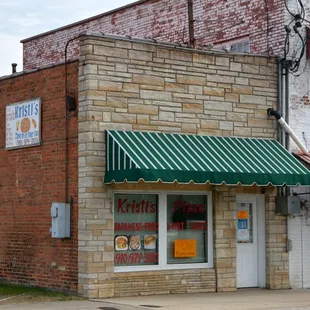 a brick building with a green awning