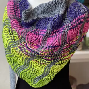 Bright-colored brioche shawl.