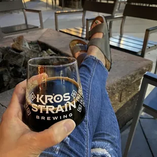 a person holding a glass of beer