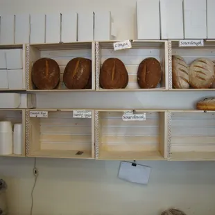 Daily specialty breads, back wall, behind the register.