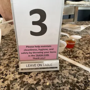 a table with a sign that says leave on table