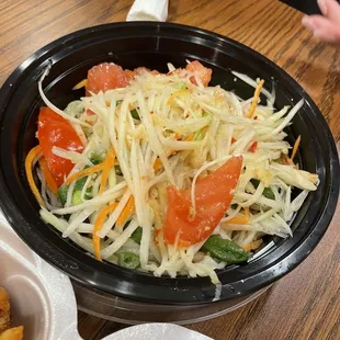 a salad in a black bowl