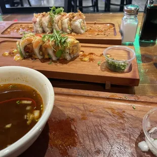 a bowl of soup and a plate of sushi