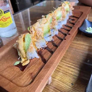 a sushi roll on a wooden platter