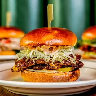 three burgers on plates
