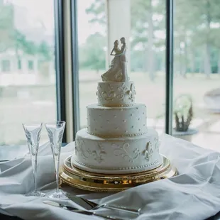 Almond-flavored wedding cake with buttercream icing and white-chocolate fleur de lis.