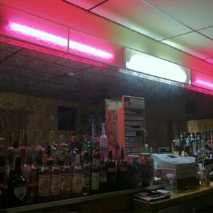 a neon sign above the bar