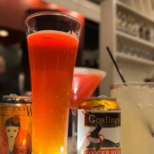 a cocktail, a ginger beer, and a can of goslingings