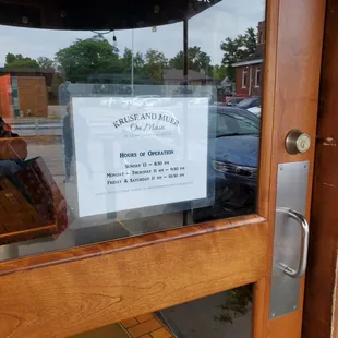 Back entrance door with hours from large parking lot.  Sunday 9/17/2023