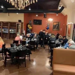 a photo of a restaurant with people sitting at tables