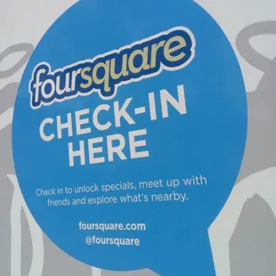a sign for foursquare check in here