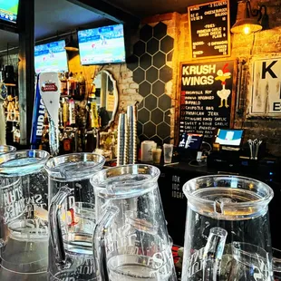 a row of empty glasses on a bar