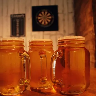 three jars of honey on a table