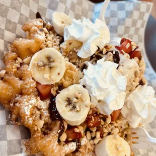 Build your own funnel cake...cookies and cream ice cream, strawberries, banana, chocolate sauce, peanuts and whipped cream.