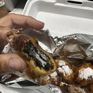 Fried Oreo Cookies drizzled in chocolate sauce and whipped cream