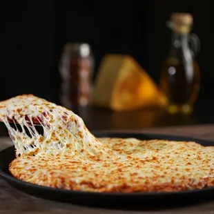 a slice of cheese pizza being lifted by a fork