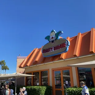 people eating outside of krusty burger