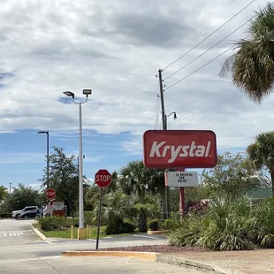 a krystal sign on a street corner
