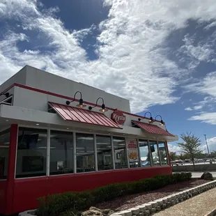 a red and white restaurant with a red awning