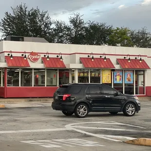 a car parked in front of a fast food restaurant
