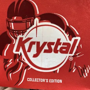 a hand holding a box of krystal