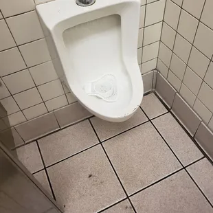 a urinal in a public restroom