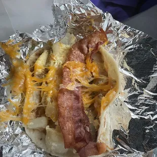 Bacon &amp; egg breakfast taco. Added beans, potatoes &amp; cheese.