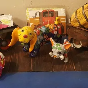 Hand made hand painted metal trucks and talavera dogs with local artist prints in back