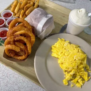 Hamburger, eggs, onion rings, fries and a Frosted Malt