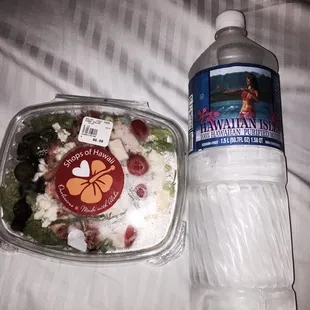 a bottle of water and a salad
