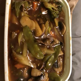 a bowl of vegetable soup with a spoon